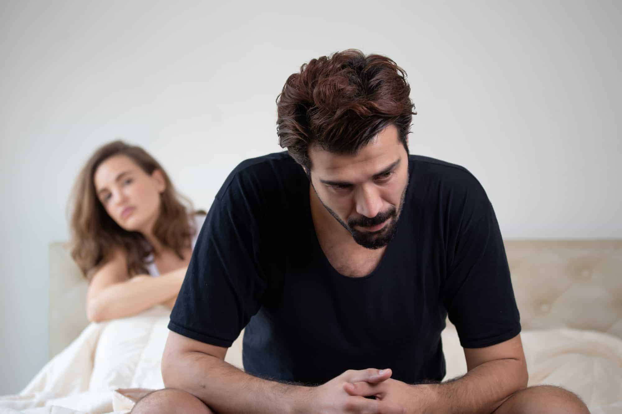 Man And Women in Bed Frustrated about his Low T symptoms